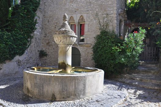 Fountain on the Rue de l'Eveche ( Haute-Ville) at Vaison La Romain, in the Vancluse, Provence, France.