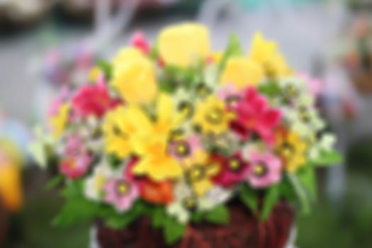 Bright and beautiful colors  plastic flowers blur background.
