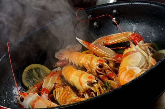 Delicious Grilled Langoustines with Lemon and Rosemary Stir-Fried in Cast Iron Pan closeup