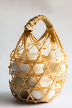 egg in basket wicker on white background,Duck eggs in baskets .