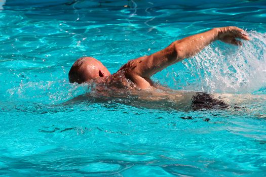 big man swimming in the pool or sea