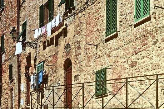 Drying Clothes on the Facade of Italian House, Vintage Style Toned Picture