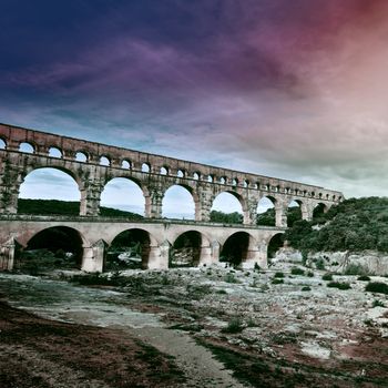 Ancient Roman Aqueduct Pont du Gard at Sunset, Vintage Style Toned Picture