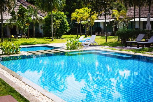 Swimming pool with reflection of trees in it