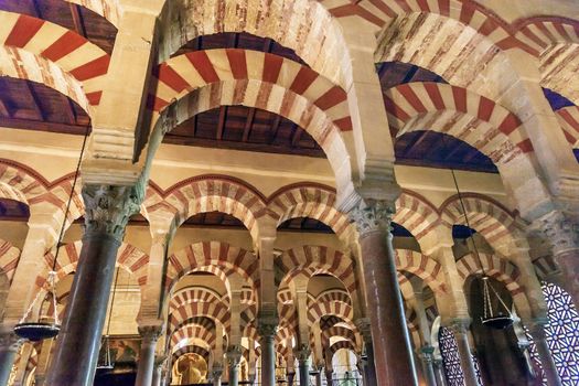 Arches Pillars Mezquita Cordoba Spain.  Created in 785 as a Mosque, was converted to a Cathedral in the 1500.  850 Columns and Arches  