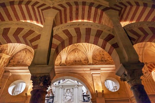 Arches Pillars Pope Mezquita Cordoba Spain.  Created in 785 as a Mosque, was converted to a Cathedral in the 1500.  850 Columns and Arches  