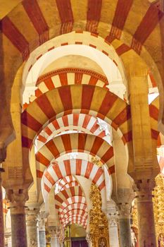 Arches Pillars Mezquita Cordoba Spain.  Created in 785 as a Mosque, was converted to a Cathedral in the 1500.  850 Columns and Arches  