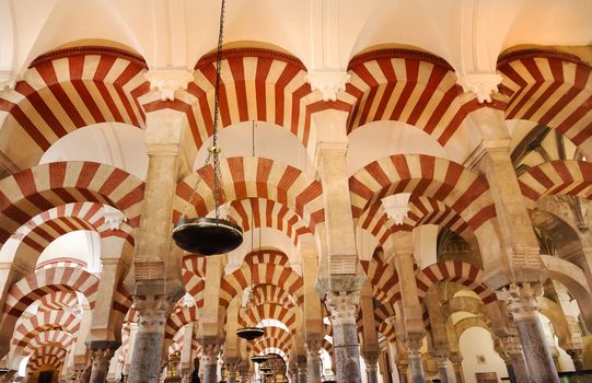 Arches Pillars Mezquita Cordoba Spain.  Created in 785 as a Mosque, was converted to a Cathedral in the 1500.  850 Columns and Arches  