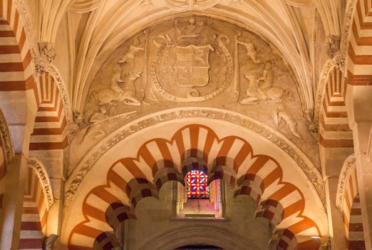 Arches Pillars Stained Glass Mezquita Cordoba Spain.  Created in 785 as a Mosque, was converted to a Cathedral in the 1500.  850 Columns and Arches  