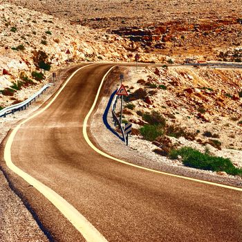 Winding Asphalt Road in the Negev Desert in Israel at Sunset, Vintage Style Toned Picture