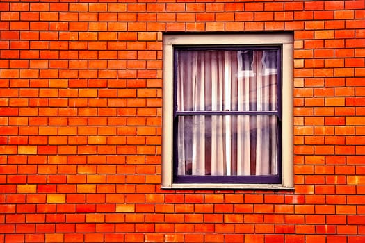 window with old orange brick wall building