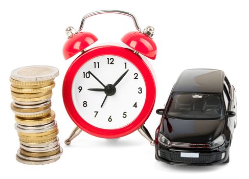 Stack of gold coins with alarm clock and car isolated on white background, closeup