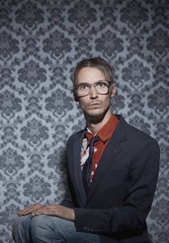 Young hipster man sitting indoors