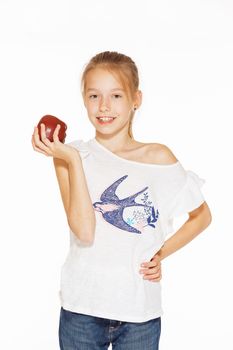 Cute little girl holding red fresh apple