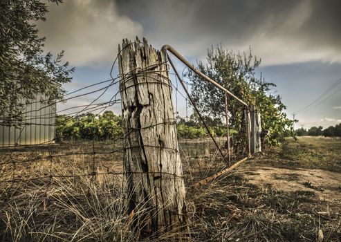 Weathered old fence post and rusted wire on a rural property in outback Australia
