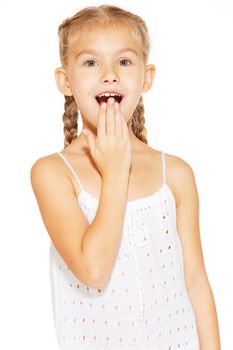 Funny little girl with a charming smile in a white dress 