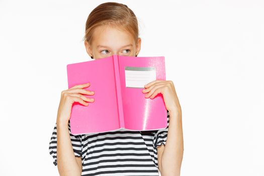 Beautiful little girl in blue dress with copybook. Isolated on white.