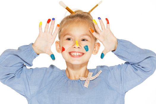 A little painter with colored fingers and a charming smile