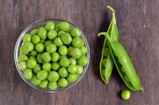 Close up of fresh peas on wooden table