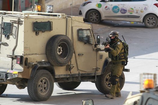 WEST-BANK, Beit Jala: Israeli forces stand by in Beit Jala on January 12, 2016 during clashes with Palestinians. At least one person died after the unrest, according to the Palestinian Health minister and Israeli army. Earlier in the day, Israeli forces shot to death a Palestinian who tried to commit a stabbing attack against IDF soldiers in Hebron. 