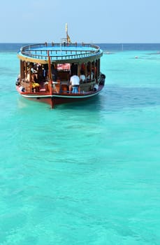 People in Ship float on the turquoise water