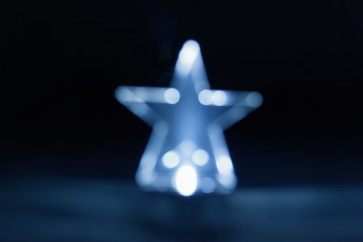 Blue Christmas star light. Decoration. Blur. Bokeh effect.