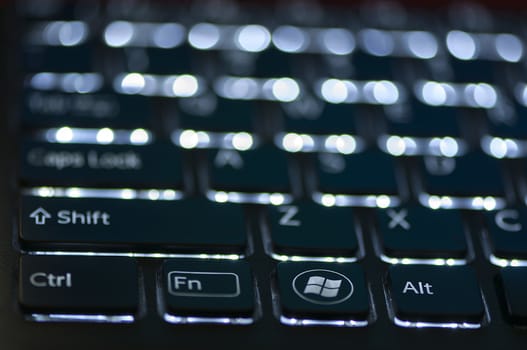 Illuminated keyboard. Focus on Ctrl Fn Alt keys. Shallow depth of field
