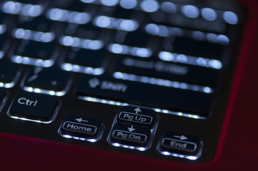 Illuminated keyboard. Focus on arrow keys. Shallow depth of field