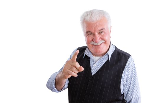 Pleased handsome male pensioner in vest with mustache on isolated background conversing and pointing finger