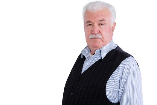 Firm and angry senior man wearing vest with intimidating and serious expression over isolated background