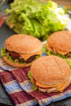 Closeup of home made burgers on wooden table