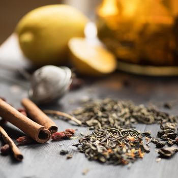 tea composition with cinnamon sticks, lemons