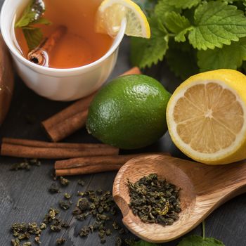 tea composition with cinnamon sticks, lemons