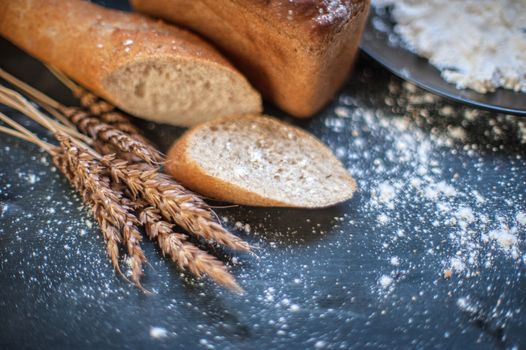 Bread composition with wheats. Very shallow DOF photo and specific art curly bokeh for extra volume.