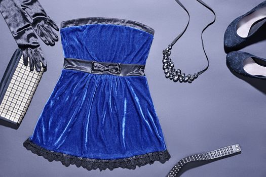 Fashion clothes stylish set, blue mini dress and accessories. Glamor creative, trendy black gloves and shiny clutch, necklace, luxury shoes heels.  Unusual elegant evening party style, copyspace