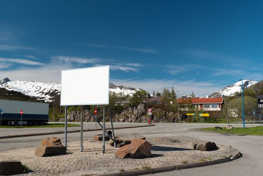 Big white bilboard on norwegian road in sunny day