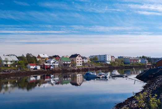 Village on the norwegian island with reflection in water