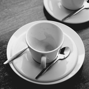 Time to reflect over a empty coffee cup in black and white