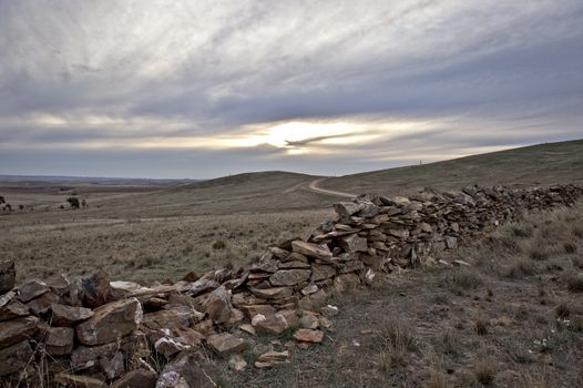 Ramshackle ancient stone fence on a rural farmland