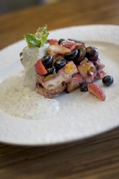 Desert of fresh berries and cream with cake and vanilla