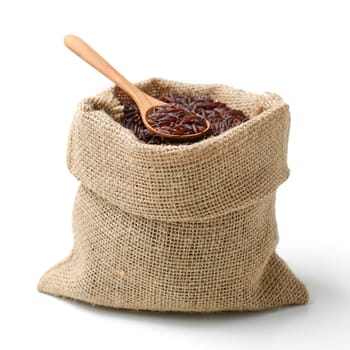 red rice in sack bag with spoon