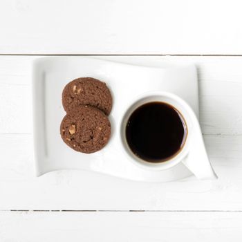 coffee cup with cookie on white wood background