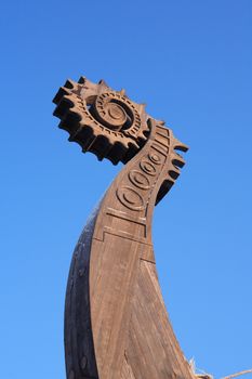 Fragment of ancient Viking ship named Drakkar against blue sky