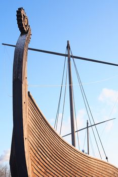 Fragment of ancient Viking ship named Drakkar against blue sky