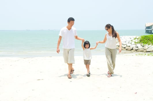 Happy family having fun at beach during summer day