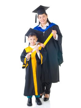 Asian mother and son in graduation gown