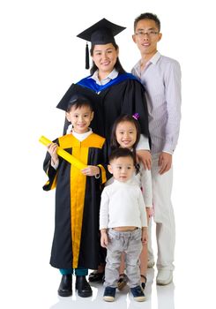 Asian mother and son in graduation gown.Taking photo with family.