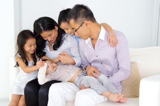 Asian family having fun at home