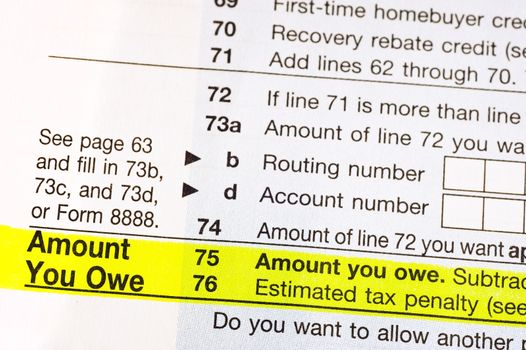 American income tax form with Amount You Owe highlighted in yellow.
