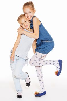 Two cute little girls hugging with a charming smile